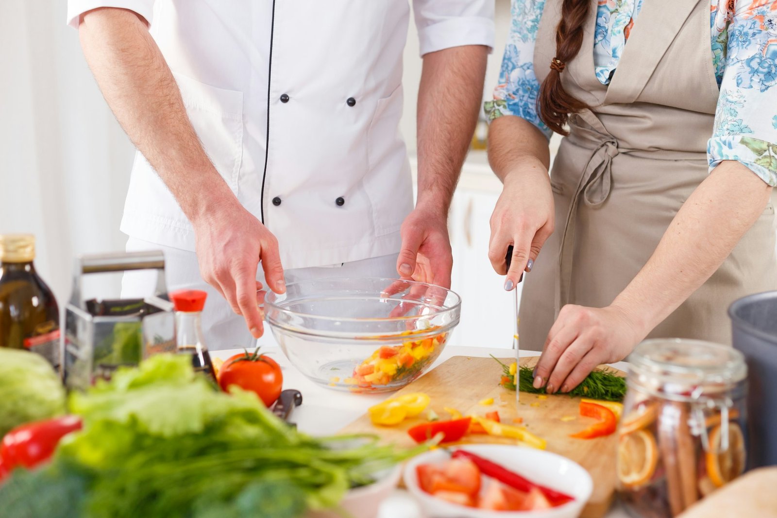 professional cook teaches to cook woman vegetarian meal.